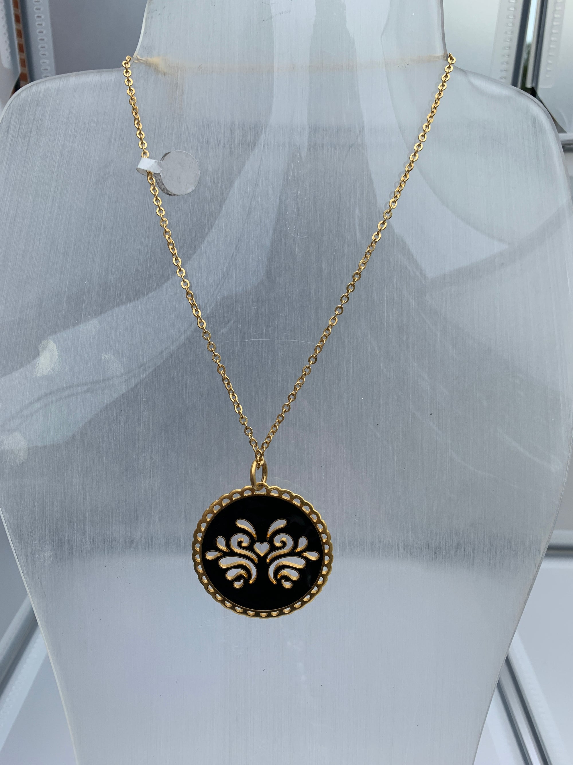 Circular reversible pendant on a chain