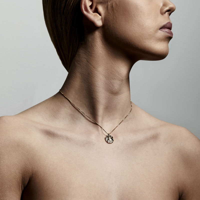 Model wearing Pilgrim Jewellery Warmth Coin Necklace in Gold