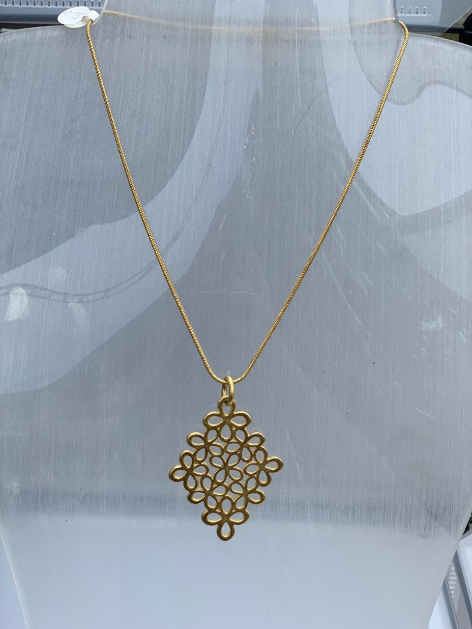 Gold plated floral diamond-shaped pendant on a snake chain